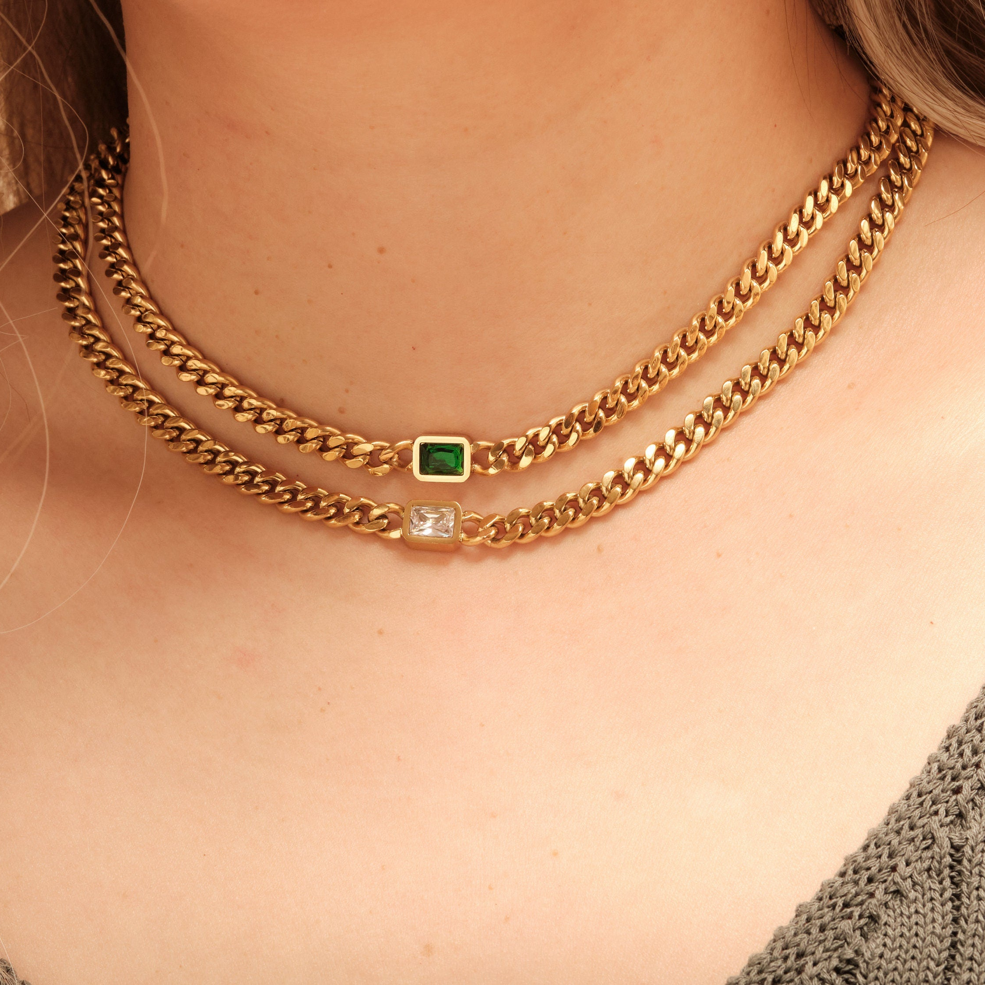 a close up of a woman wearing a gold necklace