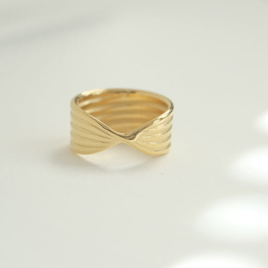 a close up of a gold ring on a white surface