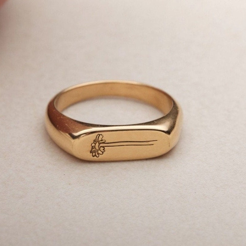 a close up of a gold ring on a table