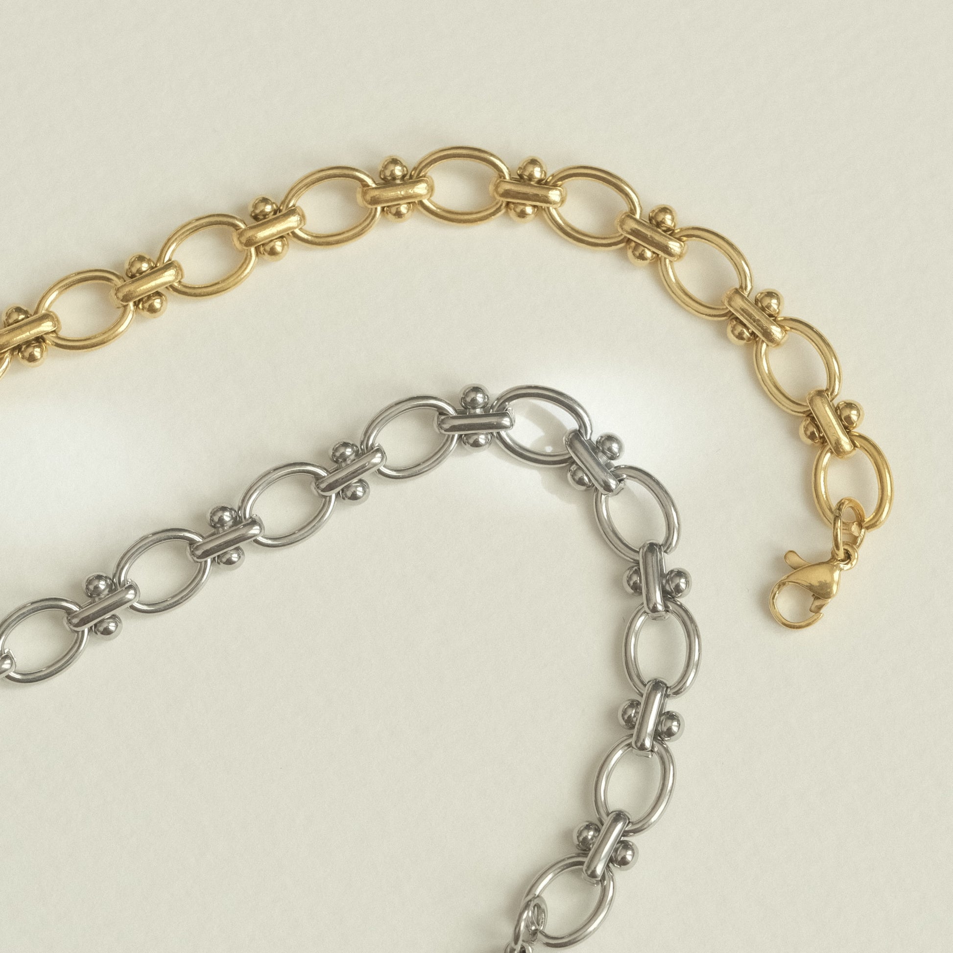 a gold and silver bracelet with a heart charm