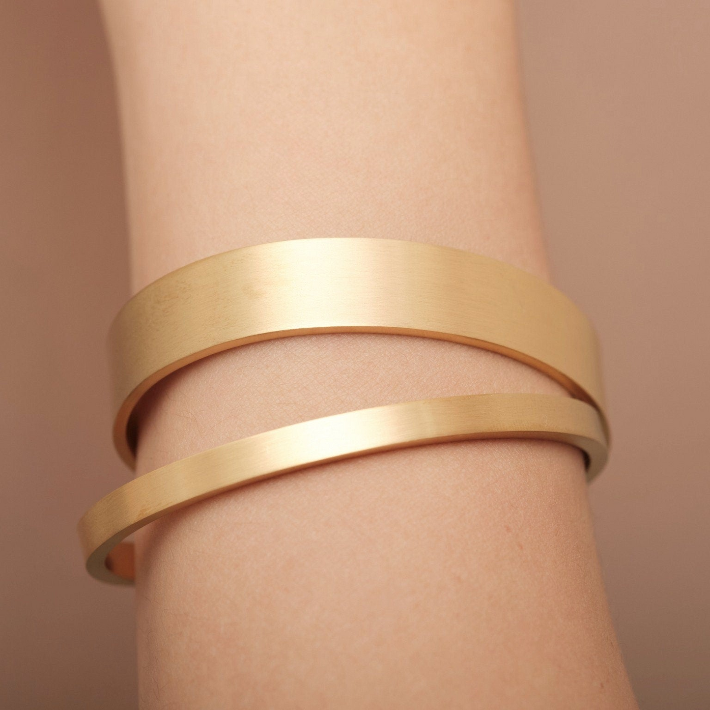 a close up of a person wearing a gold bracelet