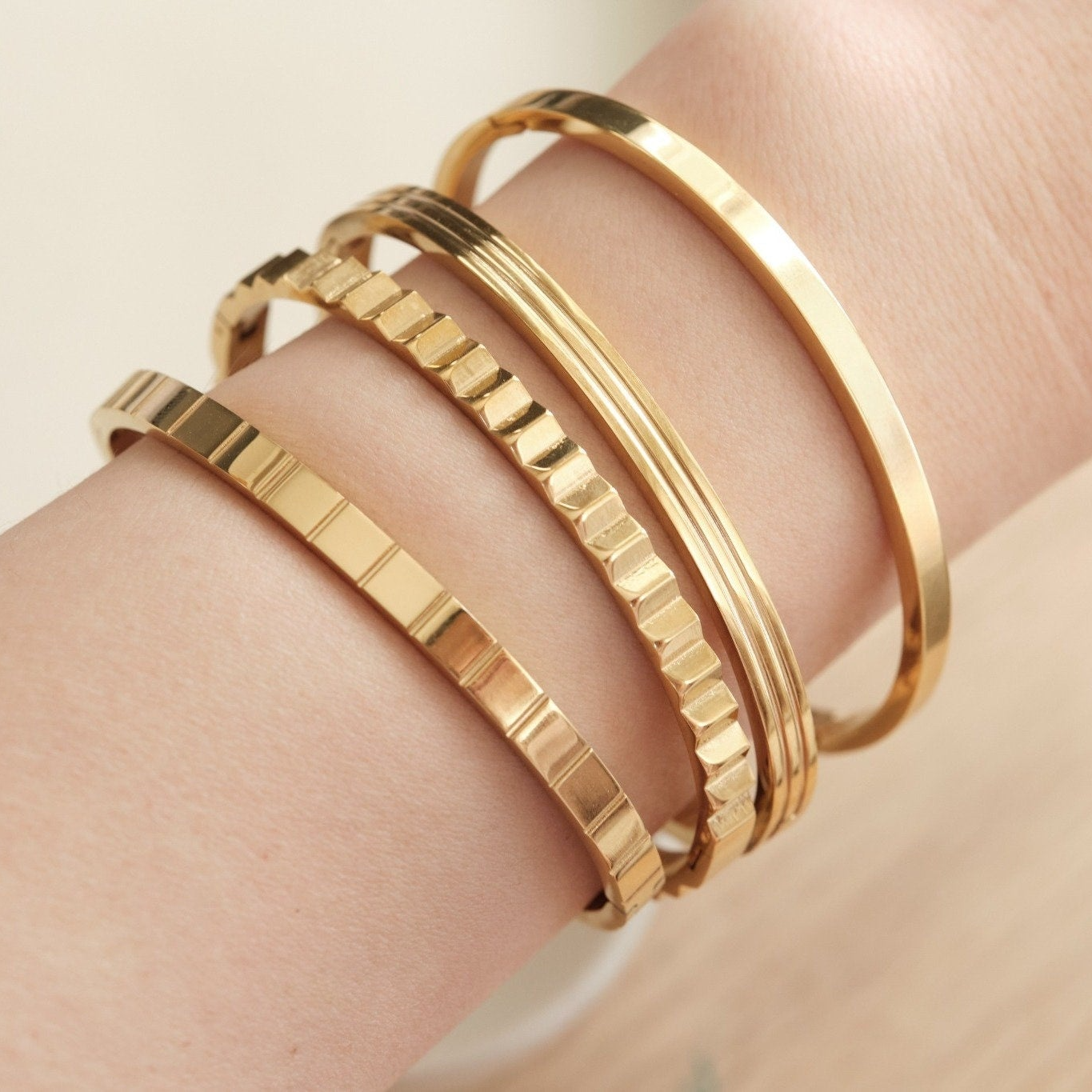 a close up of a person wearing three different bracelets