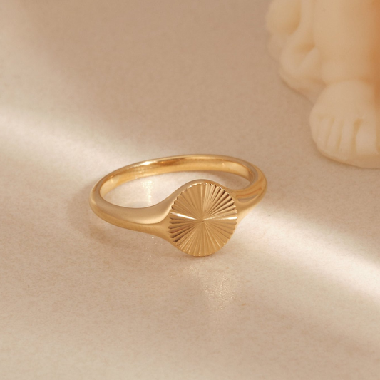 a close up of a gold ring on a table