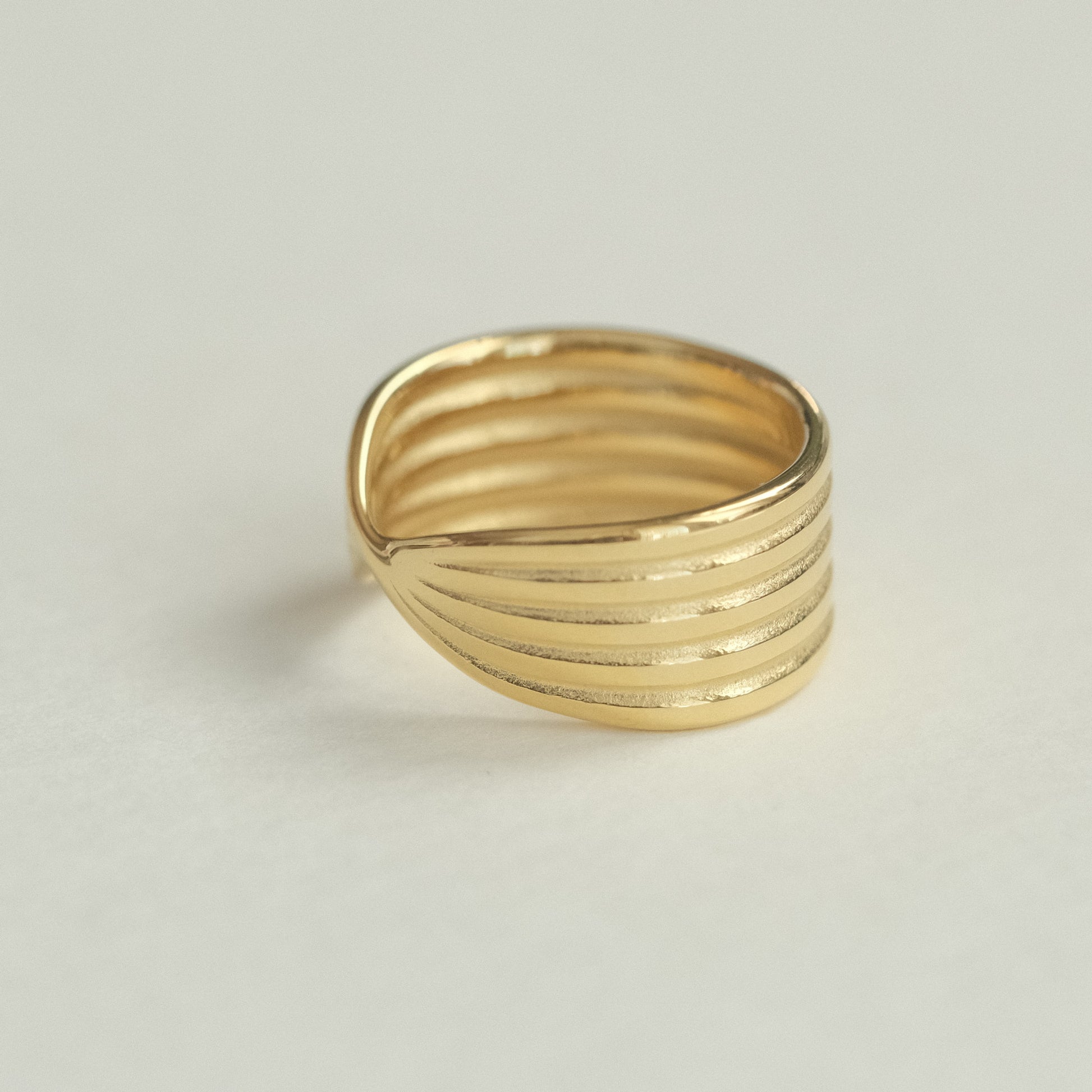 a close up of a gold ring on a white surface