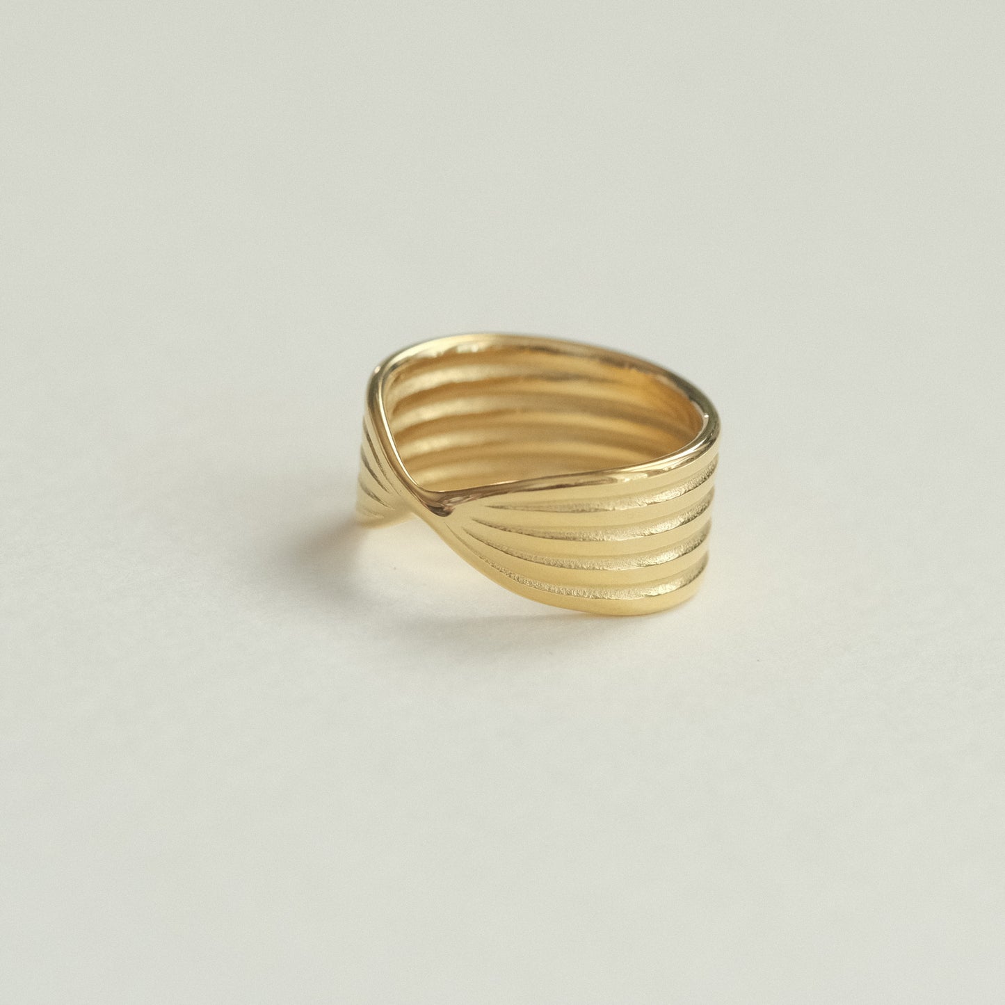 a gold ring on a white surface