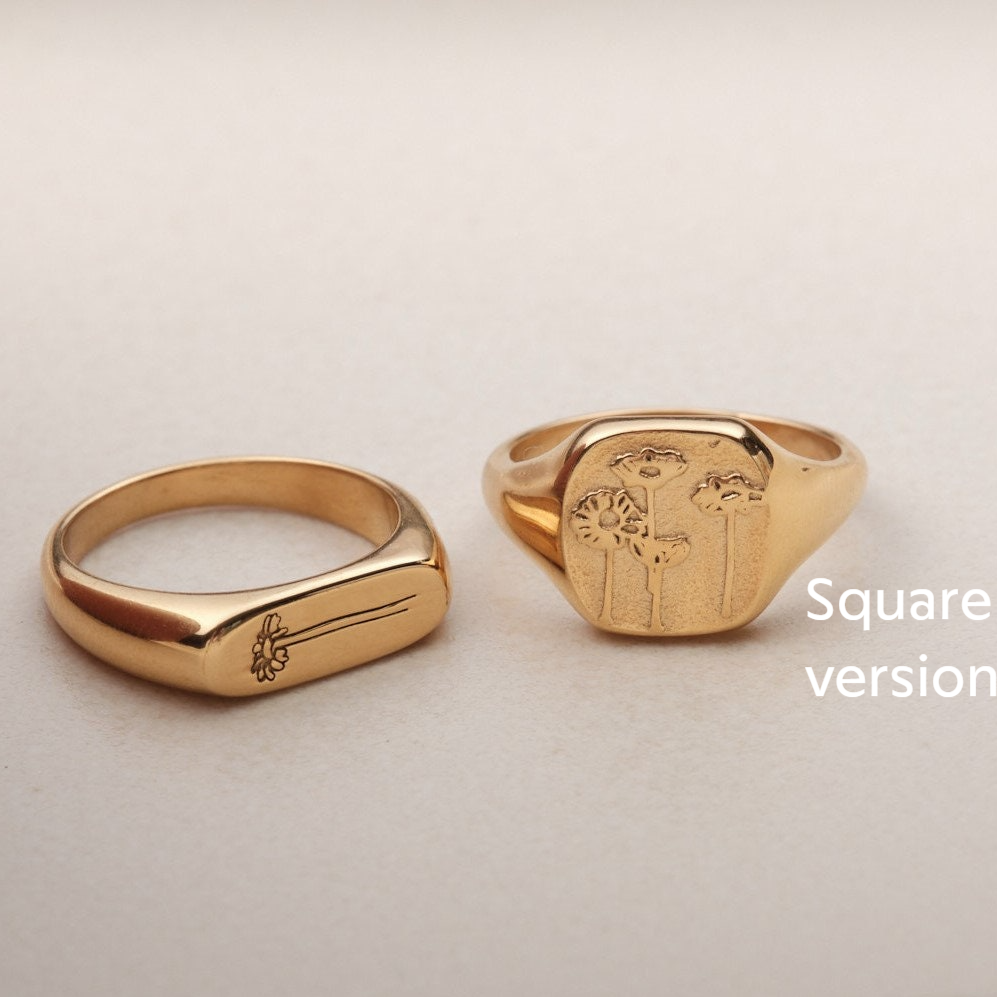 a gold ring with a picture of a man and a woman on it