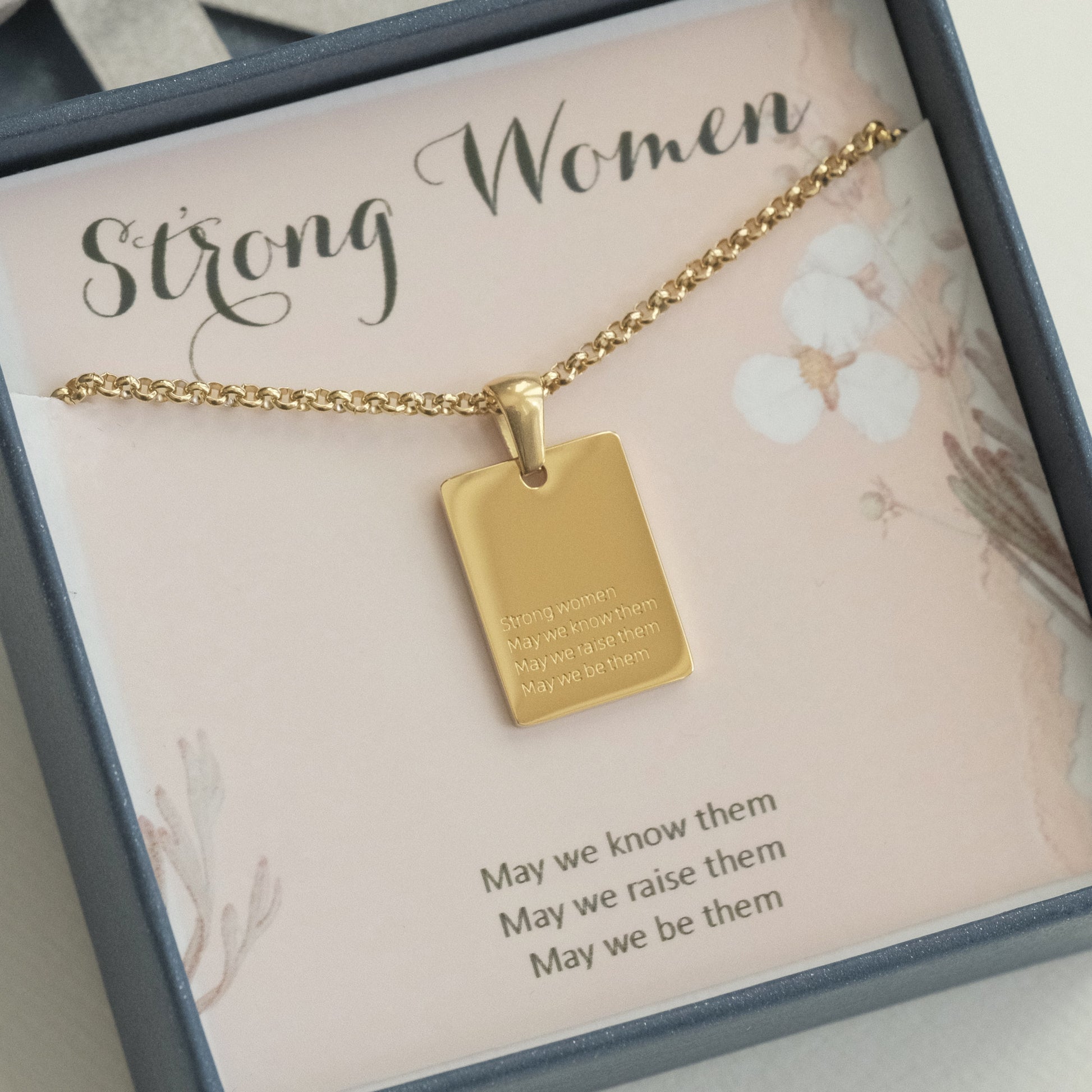 a gold necklace with a quote on it