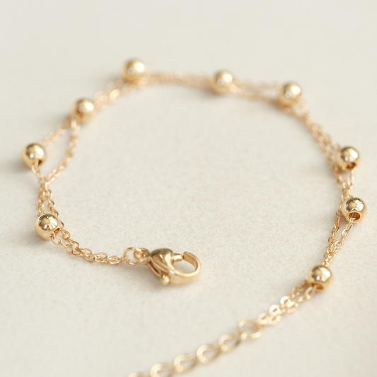 a close up of a gold chain bracelet