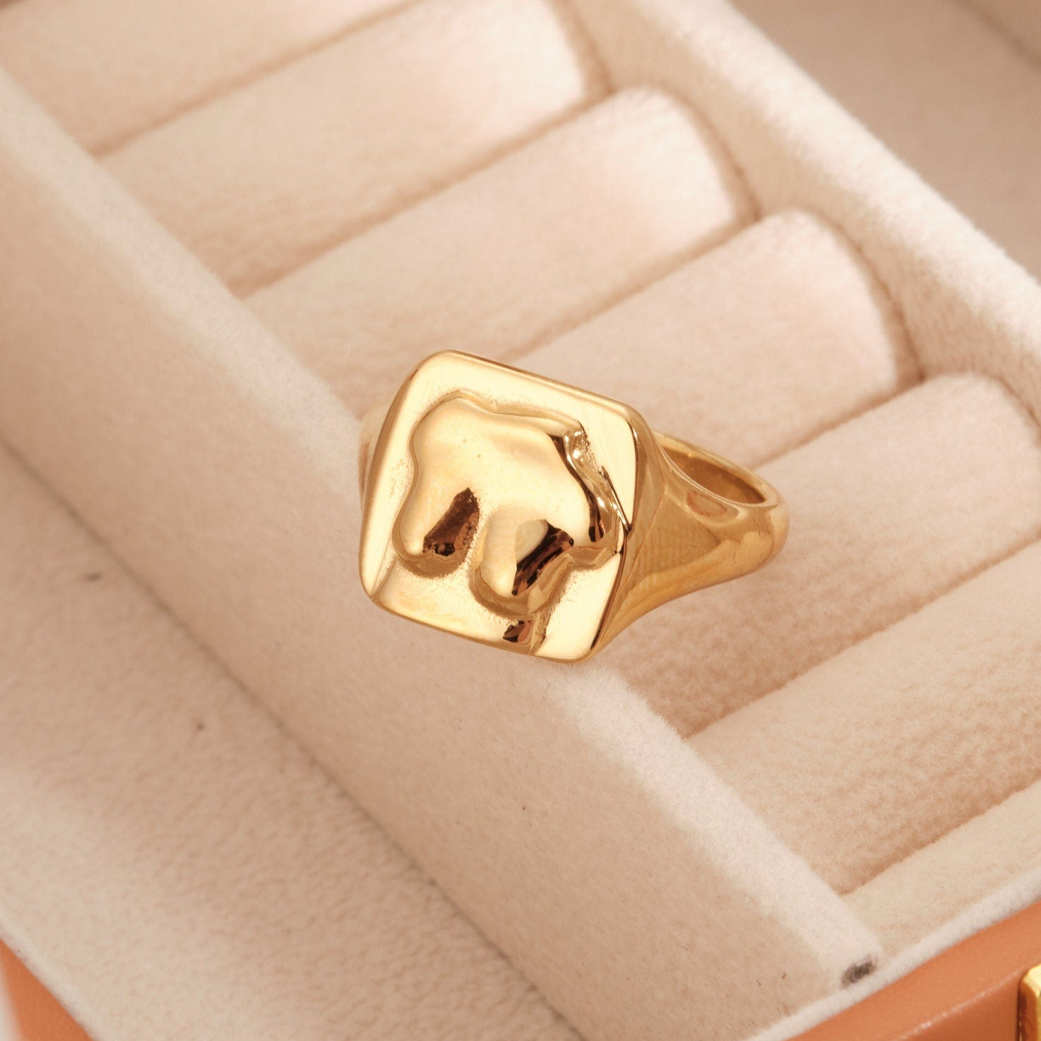 a gold ring sitting inside of a box