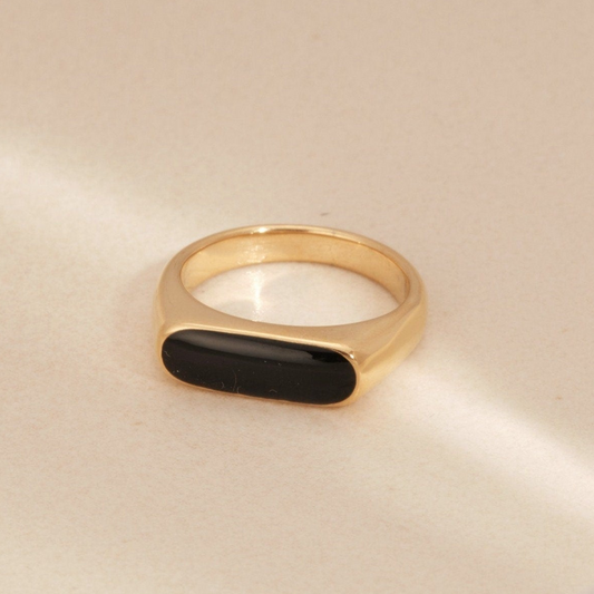 a gold ring with a black stone on it