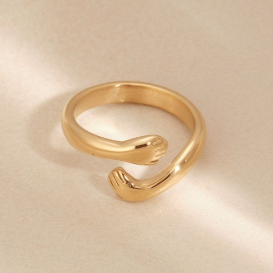 a close up of a gold ring on a white surface