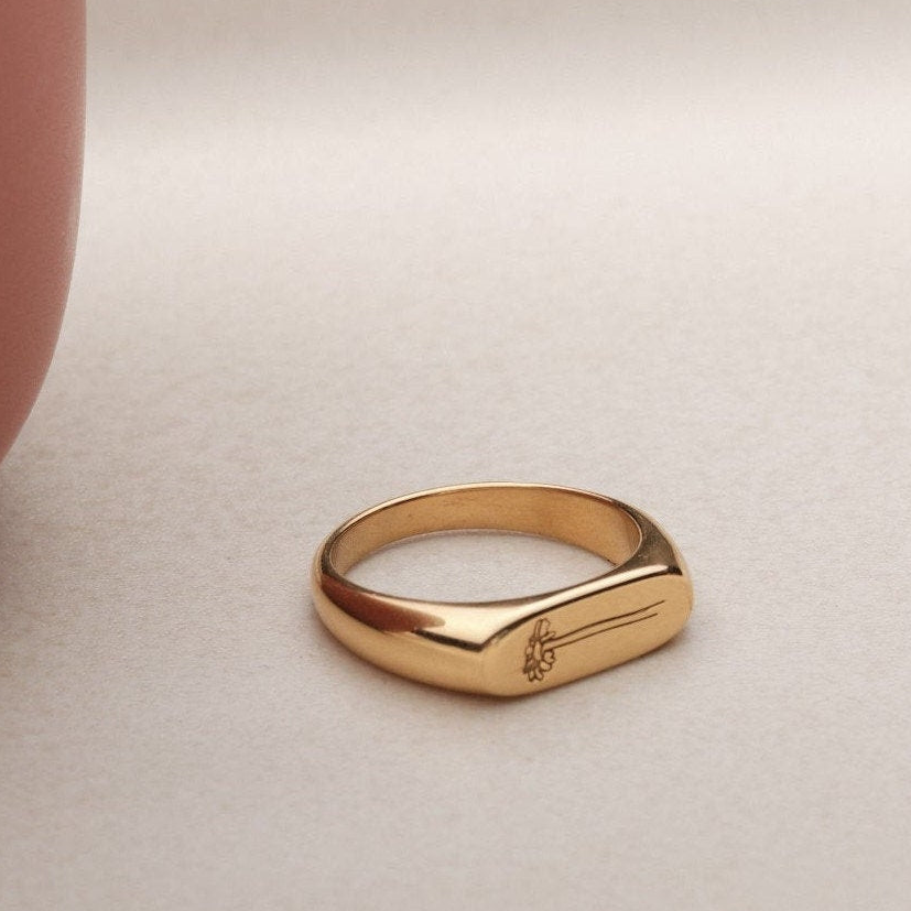 a close up of a gold ring on a table