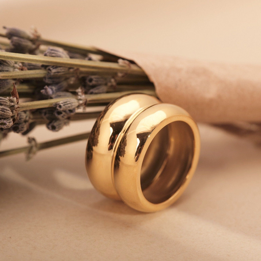 a close up of a wedding ring and flowers