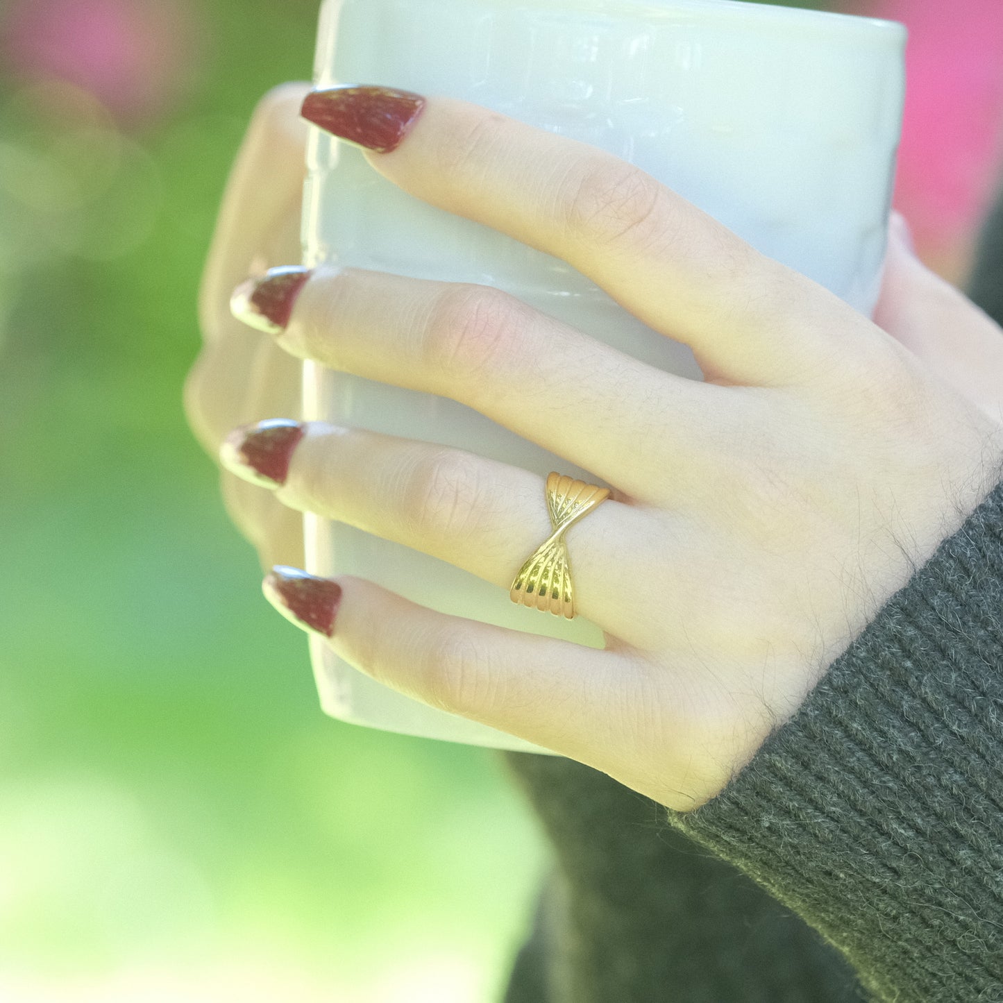 a woman's hand holding a cup of coffee