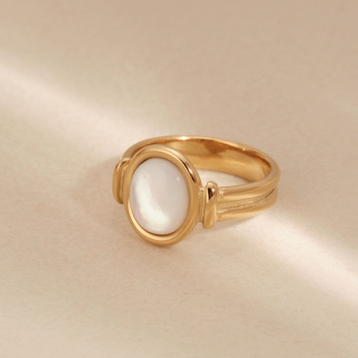 a close up of a gold ring with a white stone