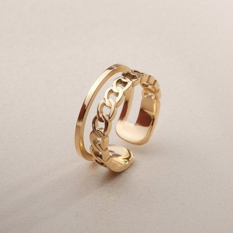 a close up of a gold ring on a white surface