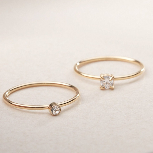 a pair of gold rings with a diamond