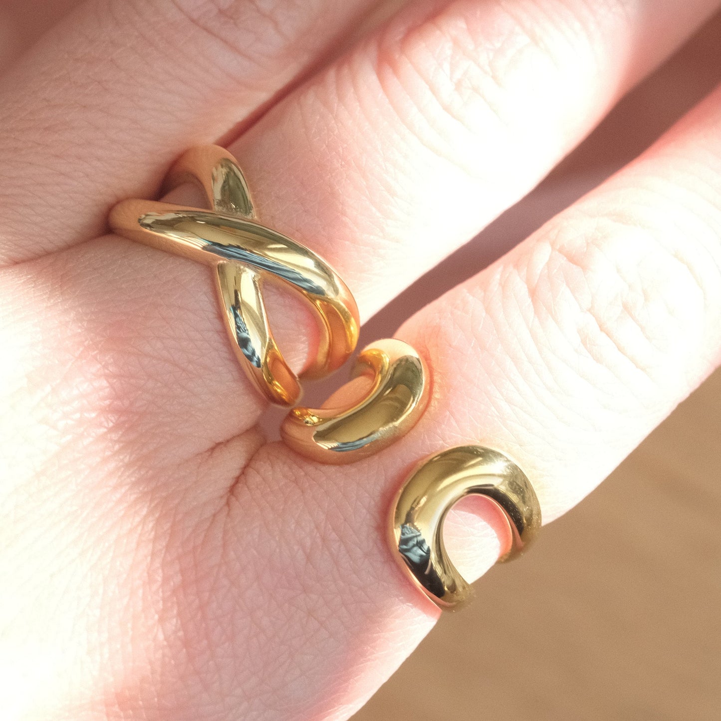 a woman's hand with a gold ring on it