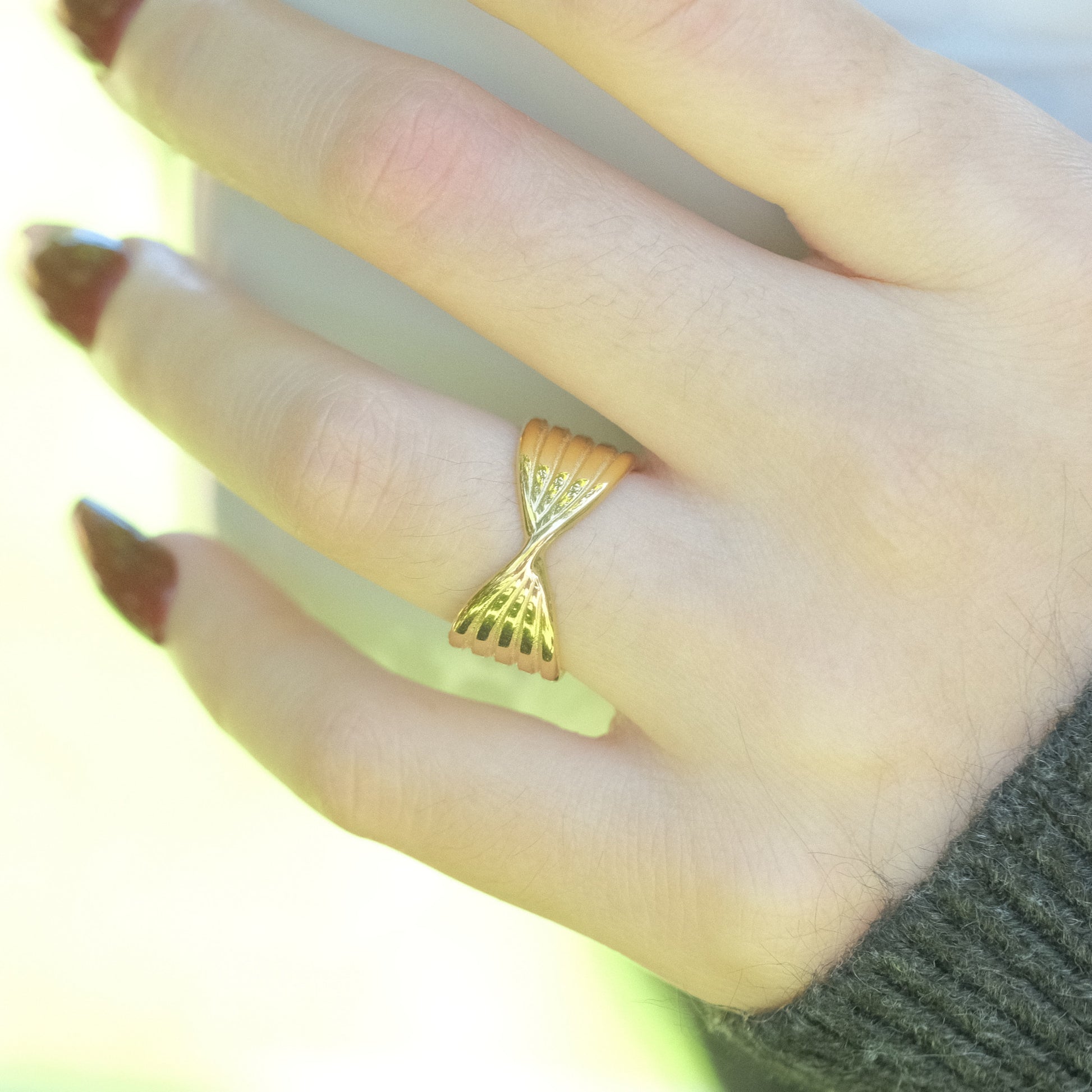 a close up of a person's hand with a ring on it