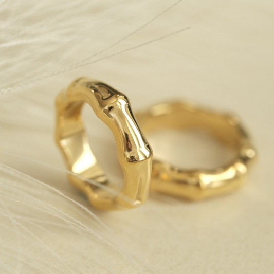 a close up of two gold wedding rings