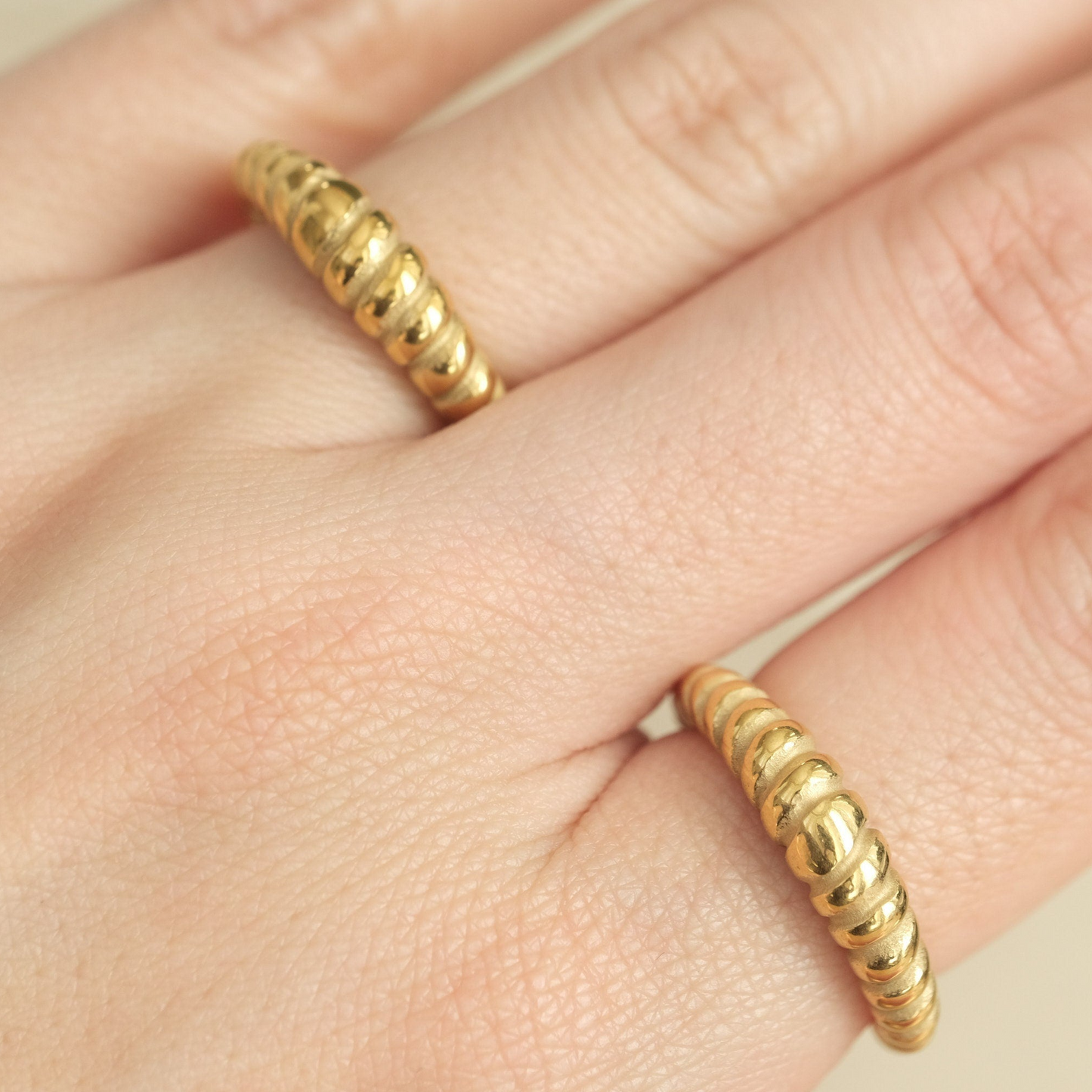 a close up of a person's hand with a ring on it