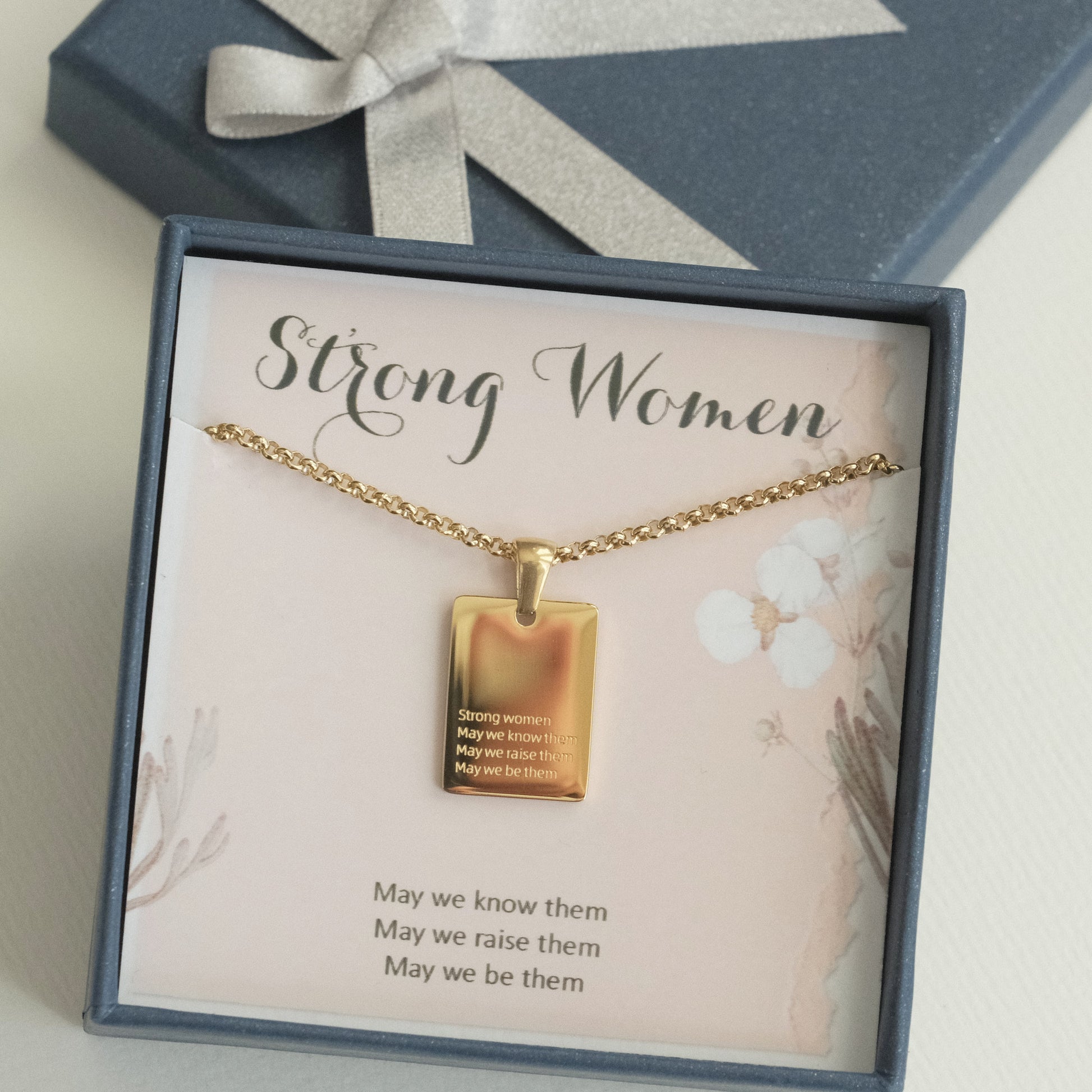 a gold necklace with a quote on it