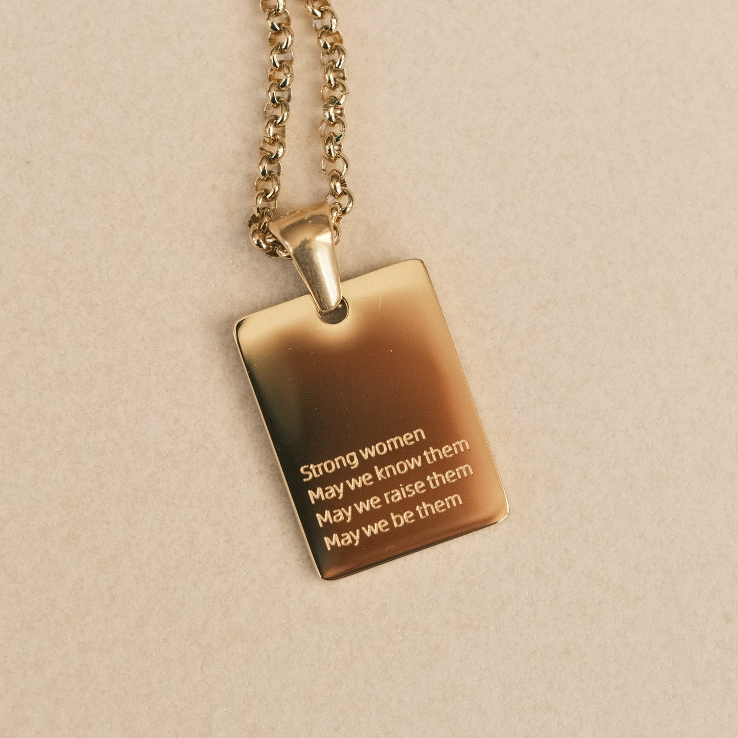 a gold necklace with a quote on it