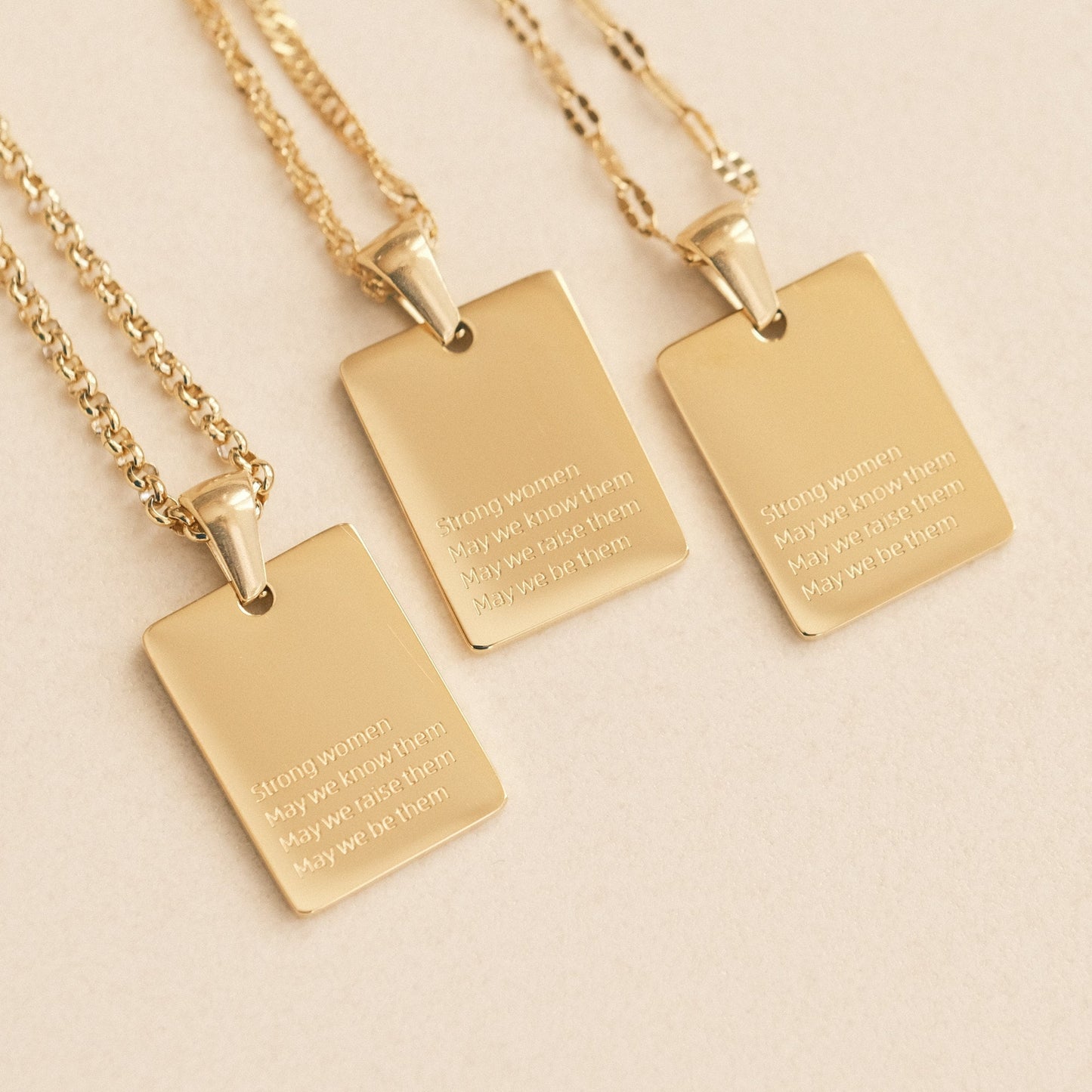 three gold necklaces with a quote on them