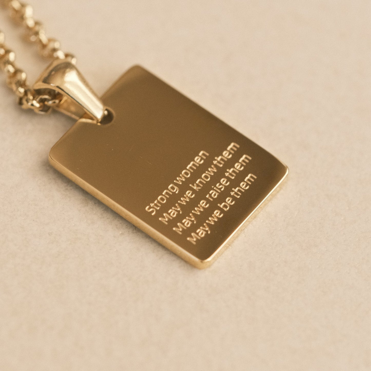 a gold necklace with a quote on it