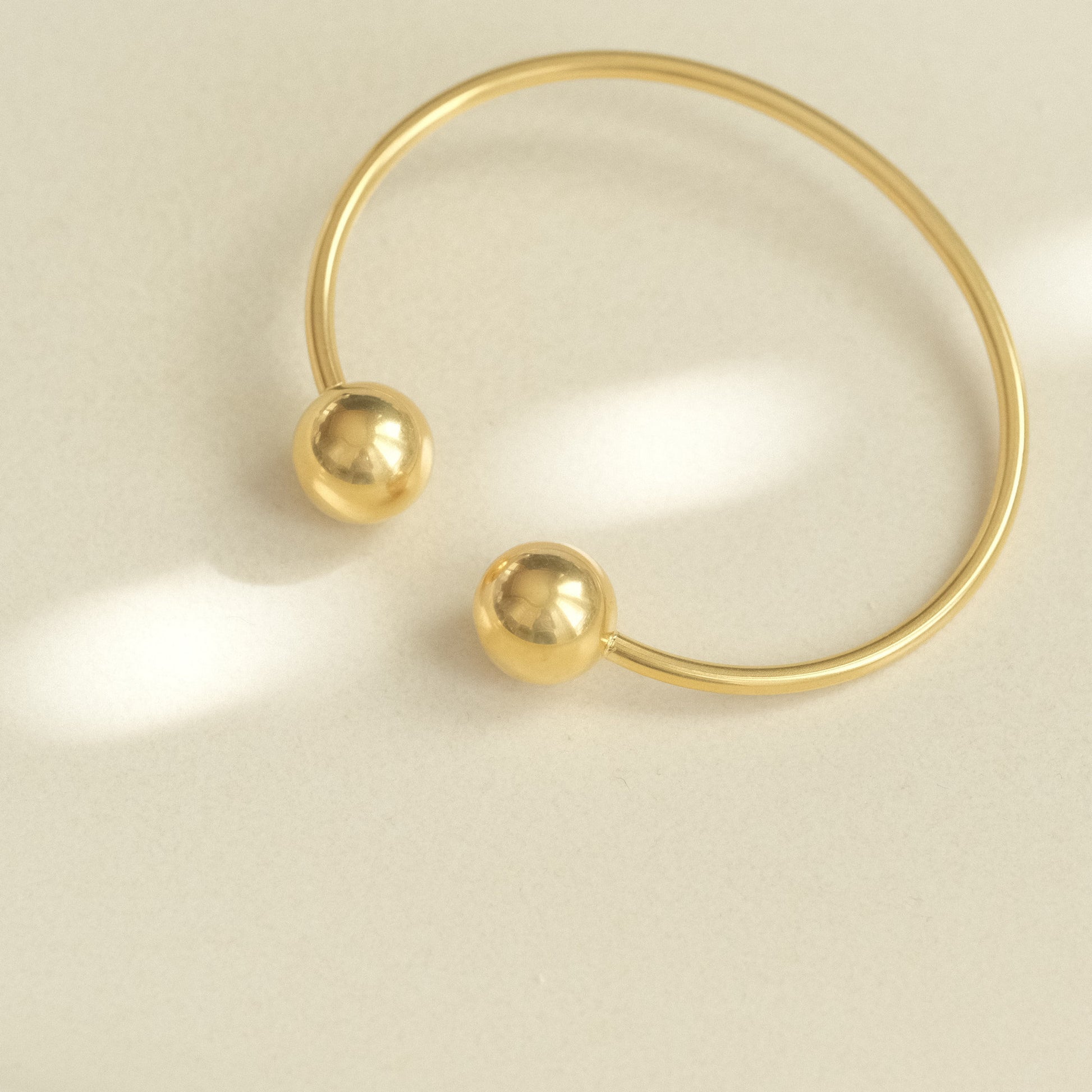 a close up of a gold ring on a white surface